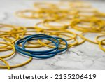 Blue and yellow rubber bands on table.