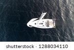 Small photo of Aerial top down view of sloop is a sailing boat with a single mast and a fore and aft rig and one head-sail vessel moving over ocean moved by wind energy beautiful steady footage 4k high resolution