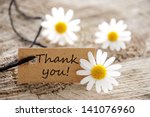 a natural looking banner with thank you and white blossoms as background
