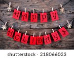Happy Holidays Greetings on red Tags Hanging on a Line with Snowflakes, Christmas or Winter Background