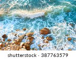 Waves On A Rocky Beach At...