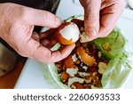 Small photo of Men's hands clean shell from boiled eggs in bucket of biological food waste. Shell cleaning, sorting food waste, using egg shells as fertilizer, compost
