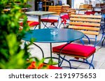 table and chairs at a sidewalk cafe - photo