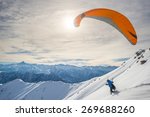Paraglider Running On Snowy...