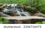 Small photo of Waterfall with empty table top old wood podium outdoor in tropical forest greenery blurred background.Organic healthy natural product present placement pedestal counter display,nature jungle concept.