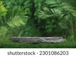 Small photo of Stone podium tabletop floor outdoors blurred green leaf tropical forest plant nature background.Beauty cosmetic natural product placement pedestal display,jungle summer concept.