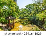 Colorful pavilion and scenic pond in Huwon Secret Garden of Changdeokgung Palace in Seoul, South Korea. Traditional Korean palatial architecture. The garden is a popular tourist attraction of Asia.