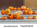 Small photo of Carved addled pumpkins are on stairs after Halloween