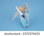 Small photo of Brain with suitcase and airplane on blue background. Brain drain concept.
