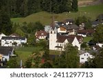 Small photo of Aerial view of the village of Ennetmoos in Nidwalden in Switzerland, with the Catholic Church of St. Jakob central. Copy space above.