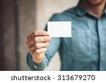 Man holding white business card ...
