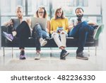 Group Adult Hipsters Friends Sitting Sofa Using Modern Gadgets.Business Startup Friendship Teamwork Concept.Creative People Working Together Marketing Project.Coworking Process Office Studio.Blurred