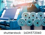 Rolls of industrial cotton fabric for clothing cloth textile manufacture on machine.