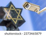 Security camera with star of David on background. Concept of monitoring religious buildings of the Jewish faith