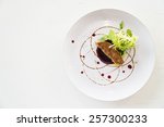 Grilled foie gras with sweet sauce in white dish - selective focus point