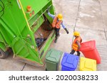 Small photo of Recyclable garbage truck and the keeper in the village.Garbage collector on the garbage truck.Sweeper or Worker are loading waste into the garbage truck carrier.