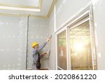 Putty plaster on the wall,Craftsman working with plaster gypsum ceiling for interior build gypsum board ceiling