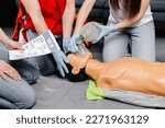 Small photo of Woman holding breathing bag Ambu bag.Demonstrating CPR Cardiopulmonary resuscitation training medical procedure on CPR doll in the class.Paramedic demonstrate first aid practice for save life.