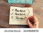 Retro effect and toned image of a woman hand writing a note with a fountain pen on a notebook. Handwritten text PRACTICE, business success concept