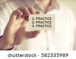 Closeup on businessman holding a card with text PRACTICE, PRACTICE, PRACTICE, business concept image with soft focus background and vintage tone