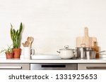 Kitchen utensils on a modern home kitchen table top, front view background with blank space for a text