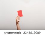 Small photo of the hand holds a red card as an attribute of punishment