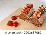 Small photo of Wonderful dessert. Rolled with fruits. Homemade cake roll with chocolate and fresh strawberry. Chocolate swiss cake. Sweet roll cake. Chocolate strawberry roll cake. Sponge roll with blueberries