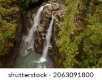 Small photo of Aerial View of the Beautiful and Dramatic Nooksack Falls. Nooksack Falls is a waterfall along the North Fork of the Nooksack River in Whatcom County, Washington and drops freely 88 feet.