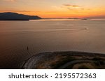 Small photo of Aerial View of a Pleasure Boat Cruising the San Juan Islands at Sunset. During a glorious sunset a runabout runs through Rosario strait seen from the coast of Lummi island.
