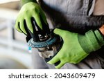 Close up of hands adjusting grinder for work. Hands and grinder. Worker in heavy industry.
