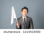 Young asian businessman showing a white flag.