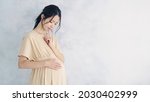 Small photo of Thinking pregnant Asian woman concept. Maternity melancholy.
