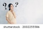 Thinking Pregnant Asian Woman...