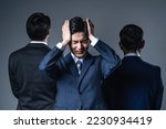 Young Asian businessman troubled between two bosses. relationship stress.