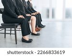 Small photo of Lining group of men and women in suits. Group job interview.