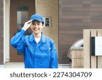 Asian male worker in front of house entrance. Delivery staff.