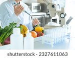 Small photo of A young researcher observing the ingredients of vegetables under a microscope. Registered dietitian.