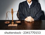 Small photo of A man in a robe and a scale. The concept of judiciary.