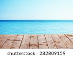Wooden Pier With Blue Sea And...