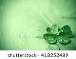St. Patricks day,  clover leaf on green wooden background