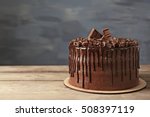 Tasty chocolate cake on grey wall background