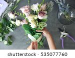 Female florist making beautiful bouquet at flower shop