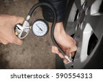 Auto Mechanic Checking Tire...