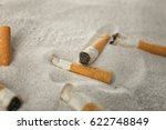 Cigarette Butts On Sand