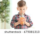 Cute Little Boy Drinking Juice...