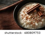 Delicious rice pudding with cinnamon in bowl, closeup