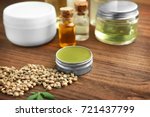 Hemp cosmetic products and seeds on wooden background