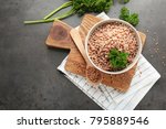 Bowl of tasty buckwheat porridge on table, top view
