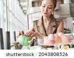 mature asian woman sitting at... | Shutterstock . vector #2043808526