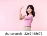 Small photo of Portrait young asian woman confident and proud showing strong muscle strength arms flexed posing, feels about her success achievement. Women empowerment, equality, healthy strength and courage concept